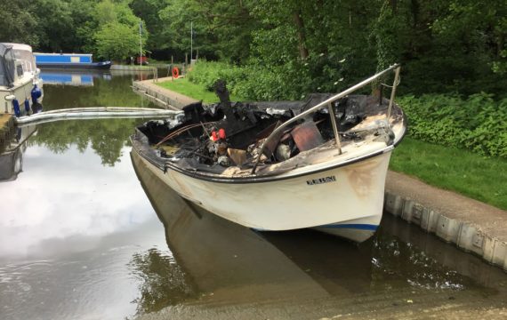 Burnt-out Freeman 22 River Boat Scrap Along Side